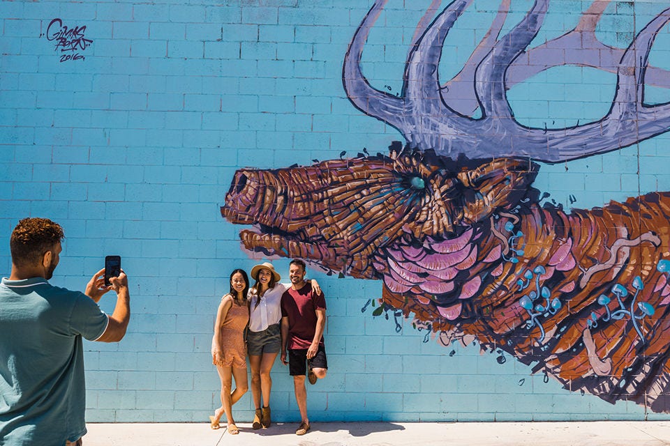 Group of friends having a photo taken by street art in Toowoomba. Image courtesy of Tourism and Events Queensland. 