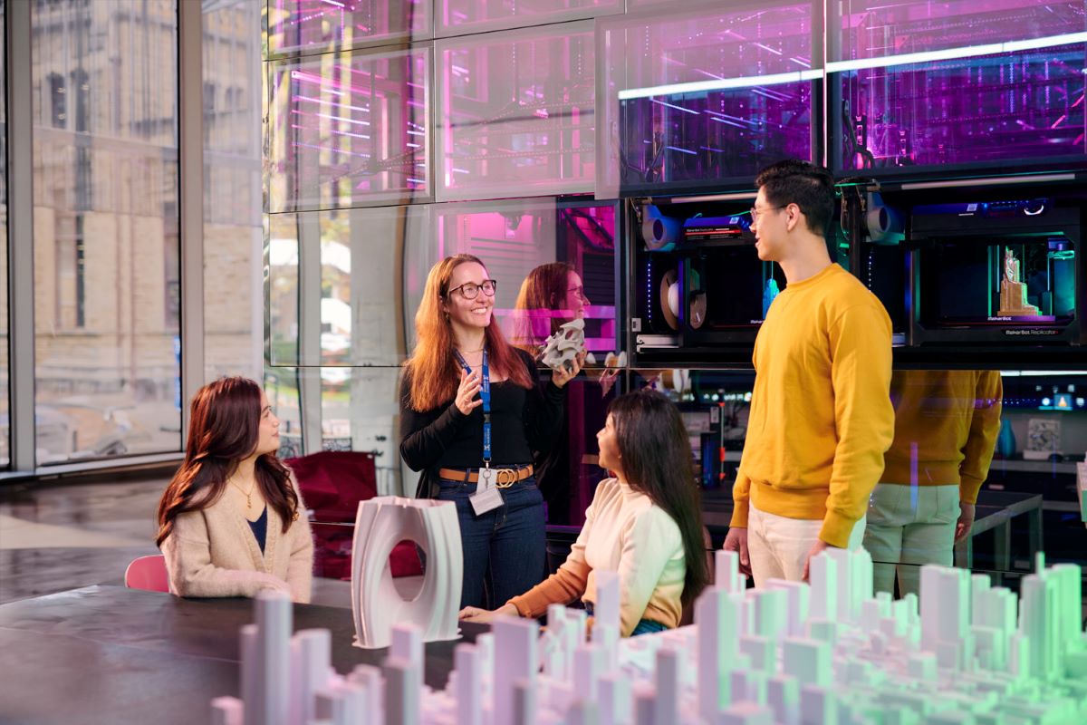 A lecturer talking to 3 students