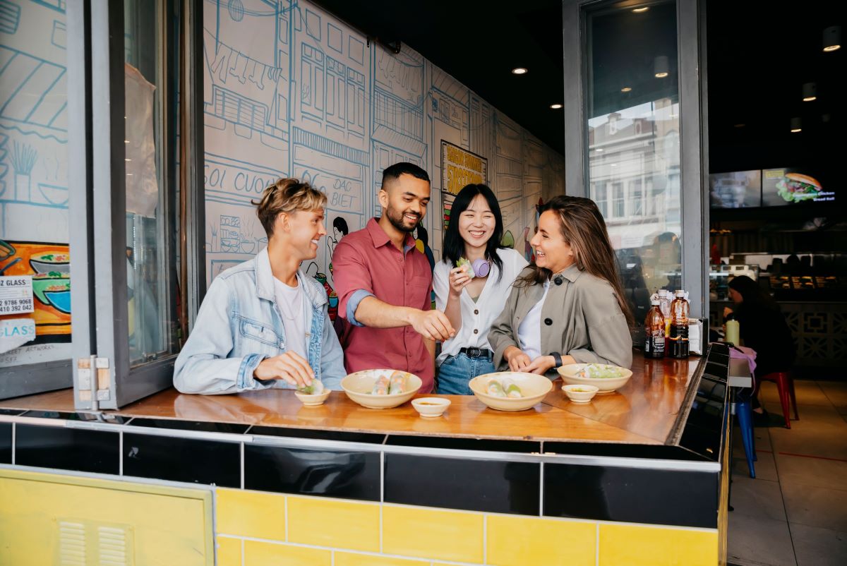 A group of international students enjoying food at a restaurant