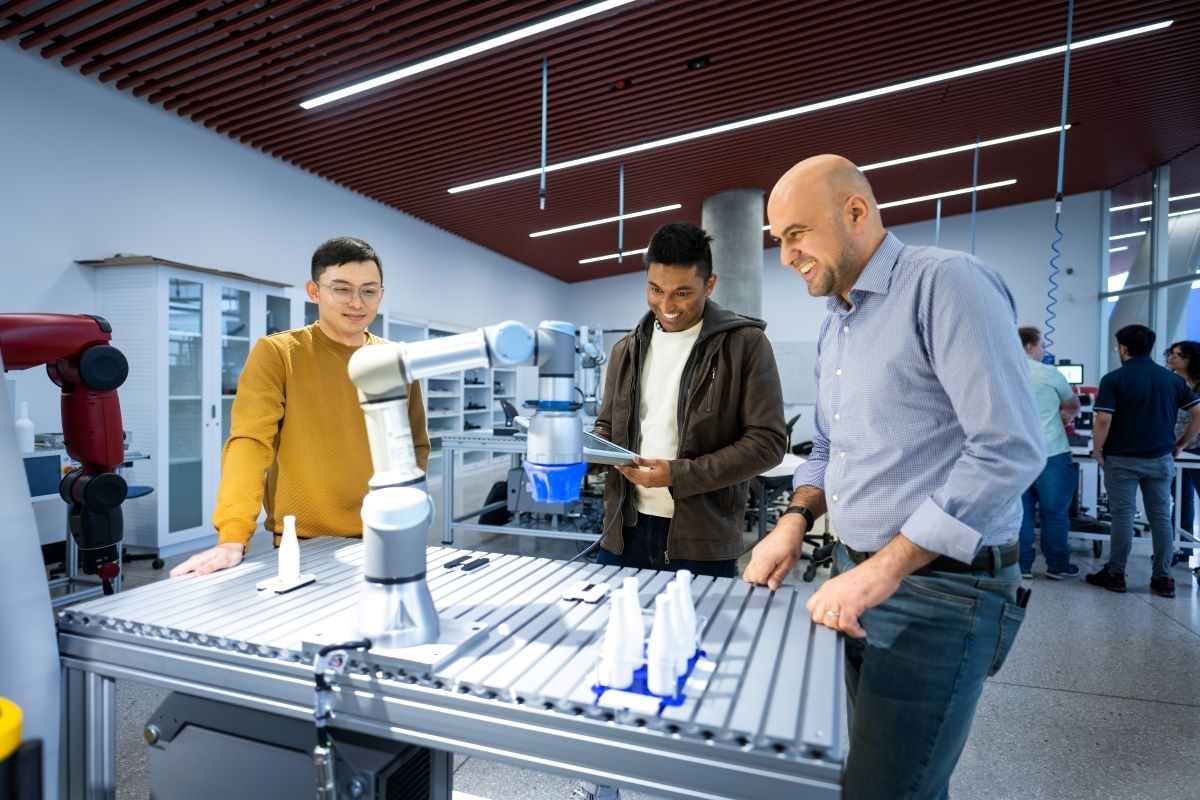 Two students with their teach in a tech lab