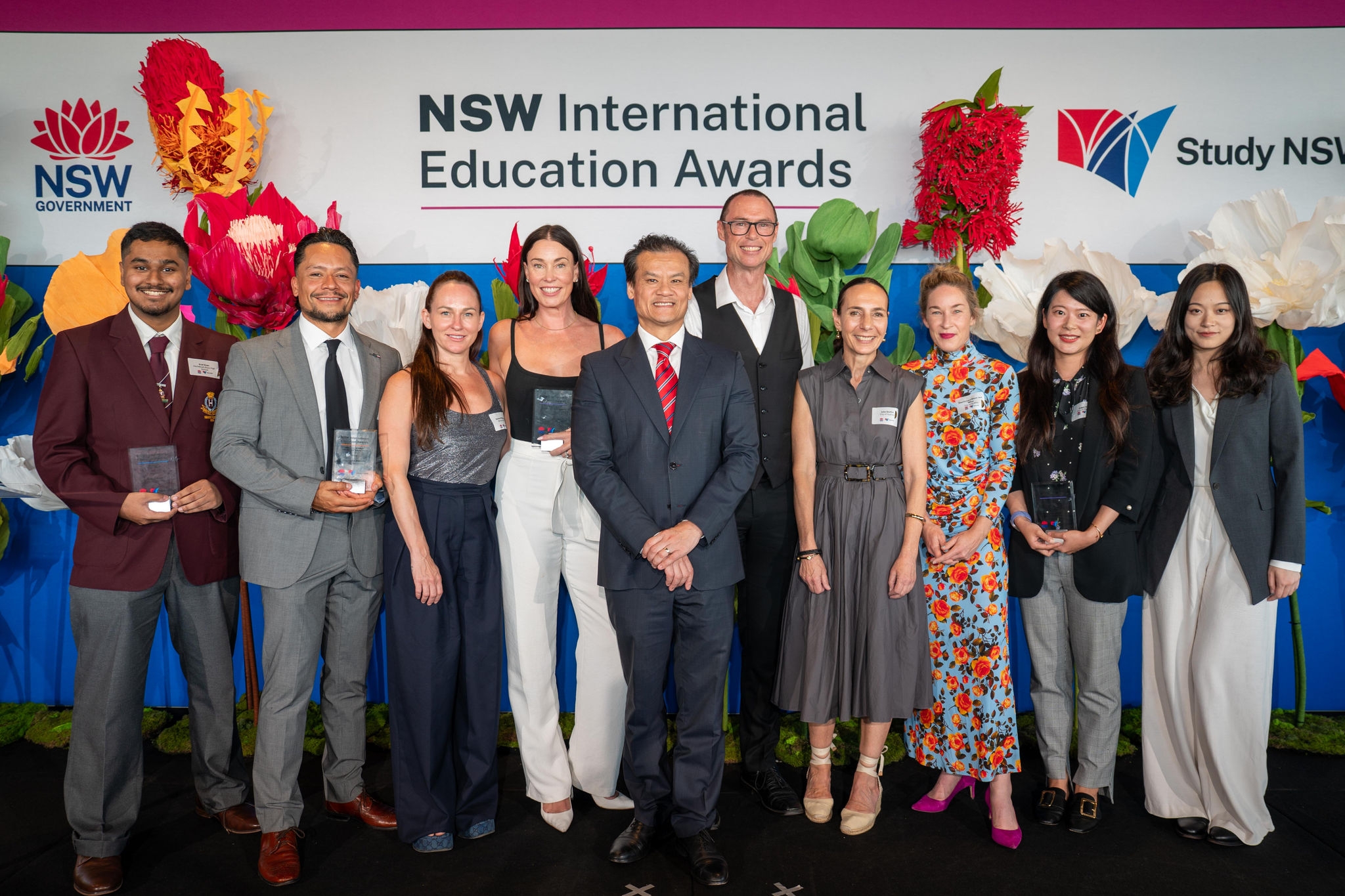 Study NSW Winners and finalists standing with their award and smiling