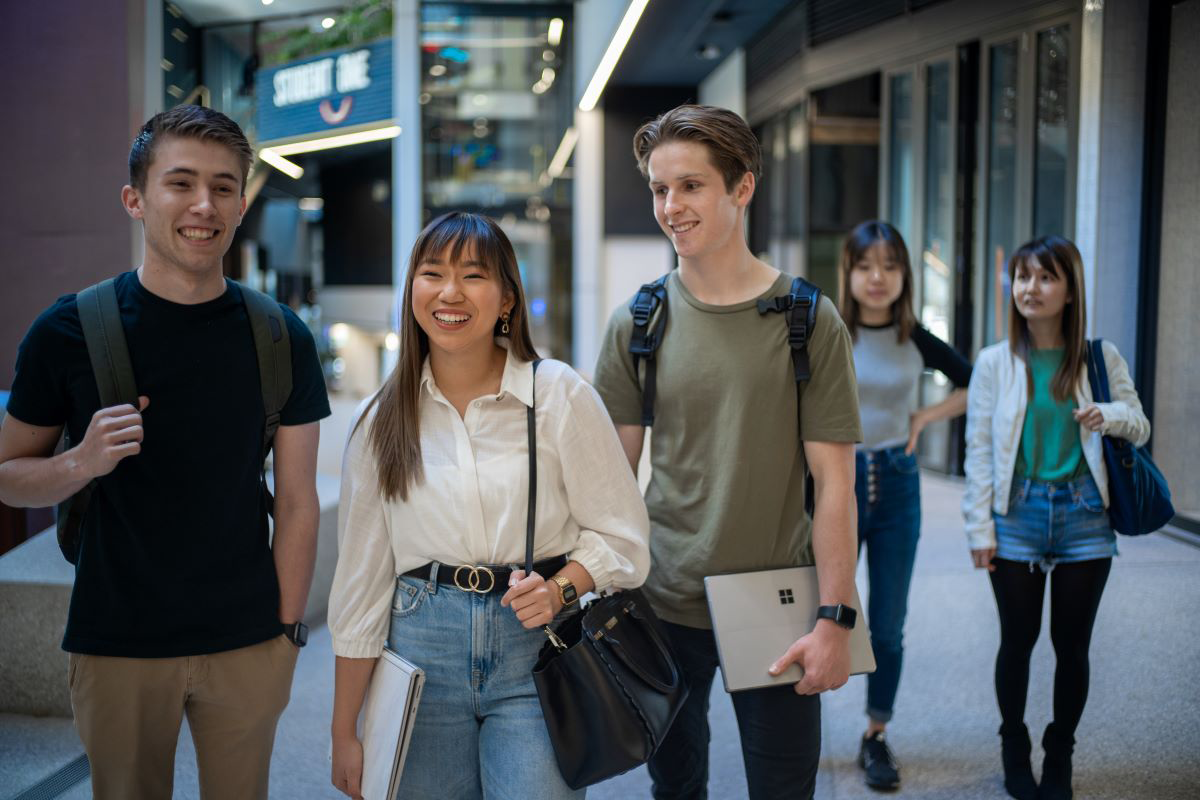 A group of international students walking down an Australian street.    