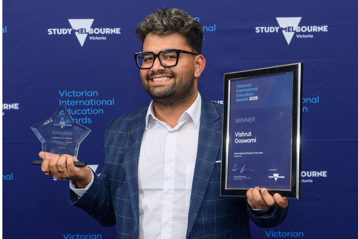 Vish holding an award