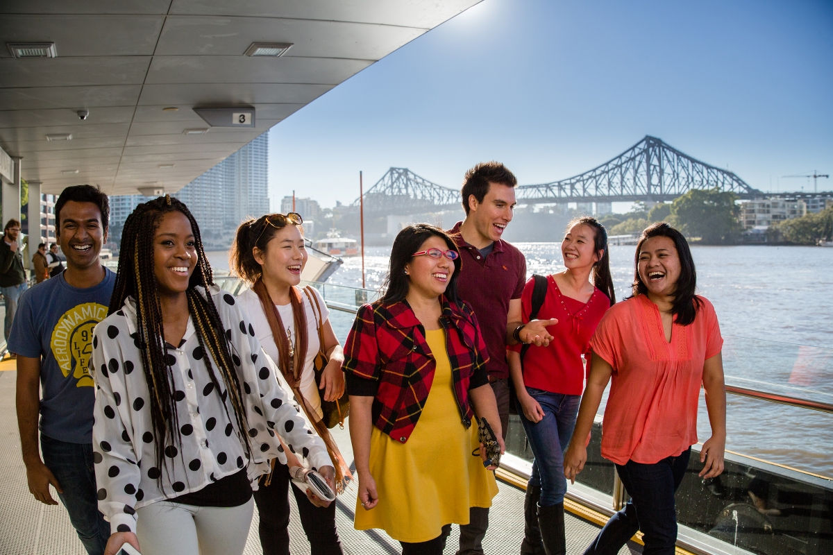 Students walking along Brisbane river 