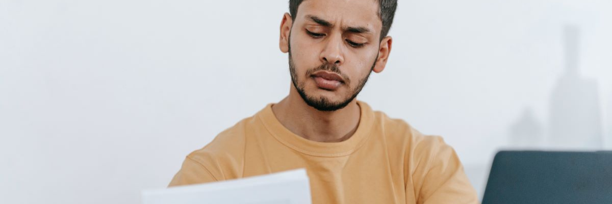 A man looking at a piece of paper