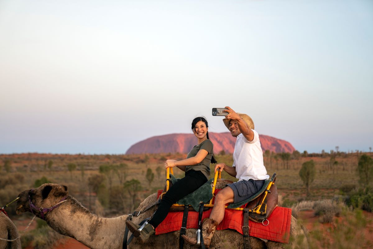 Students enjoying sunset at Uluru by camel back