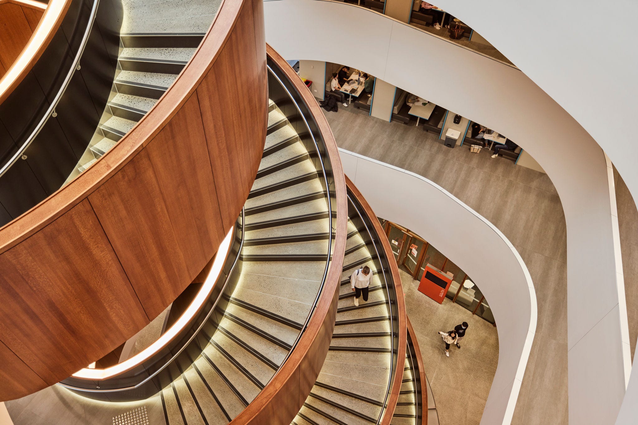Student walks down The University of Sydney spiral staircase. 