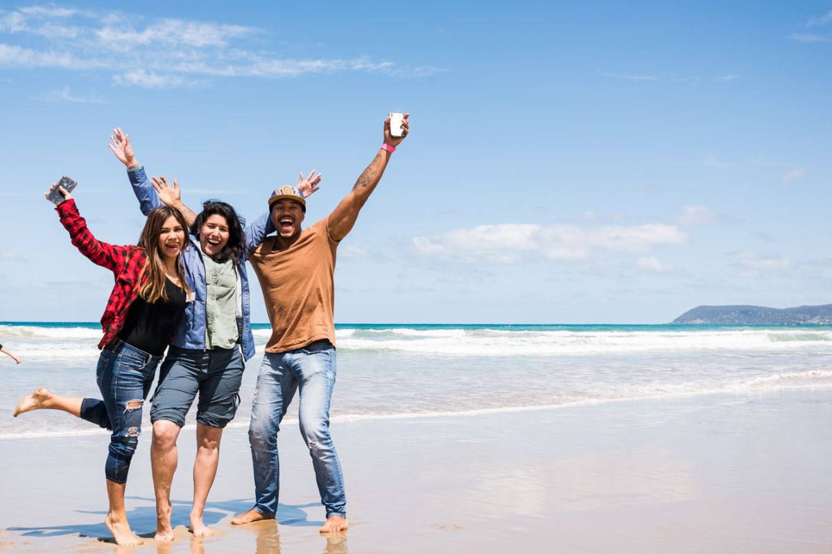 A group of international students enjoying a holiday on an Australian beach. 