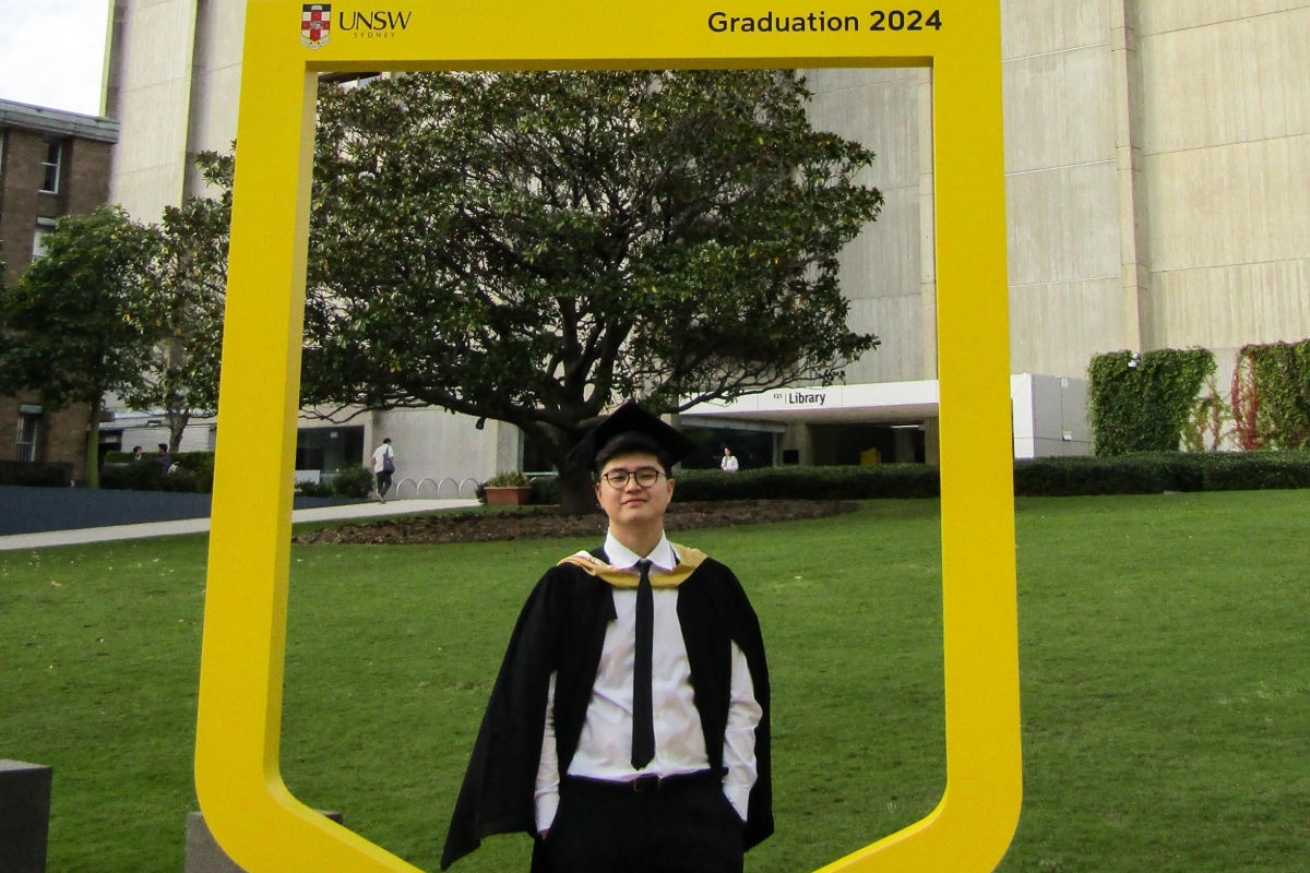 International student, Axel, in his graduation gown
