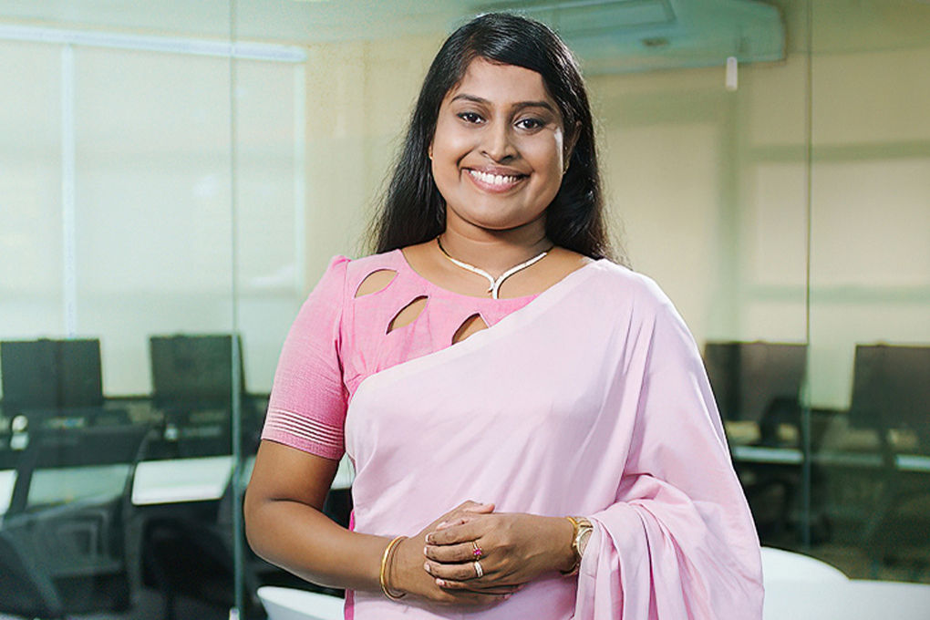 Dr. Buddhima Subasinghe stands facing the camera smiling.