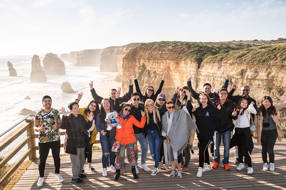 A group of international students looking out over the 12 Apostles on the Great Ocean Road, Victoria.  