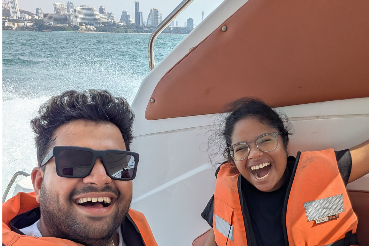 Vish on a boat with a friend laughing