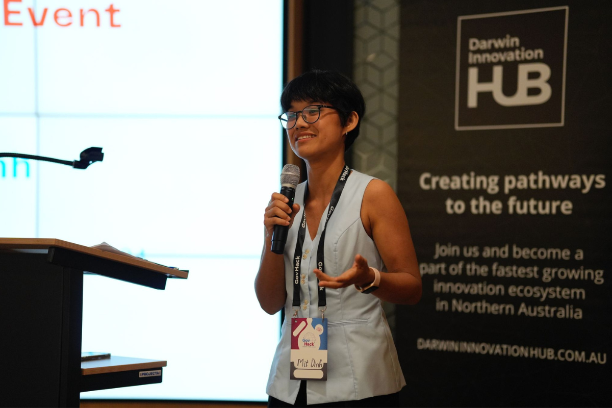 Mit holding a microphone and talking to an audience