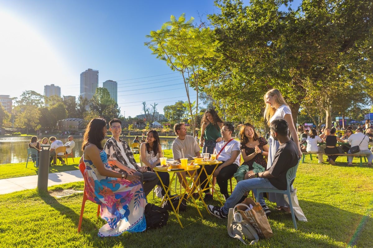 A group of friends having food and drinks at an outdoor venue