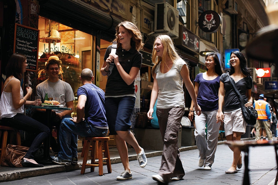 Students walking past cafes at Centre Place, Melbourne, VIC. 