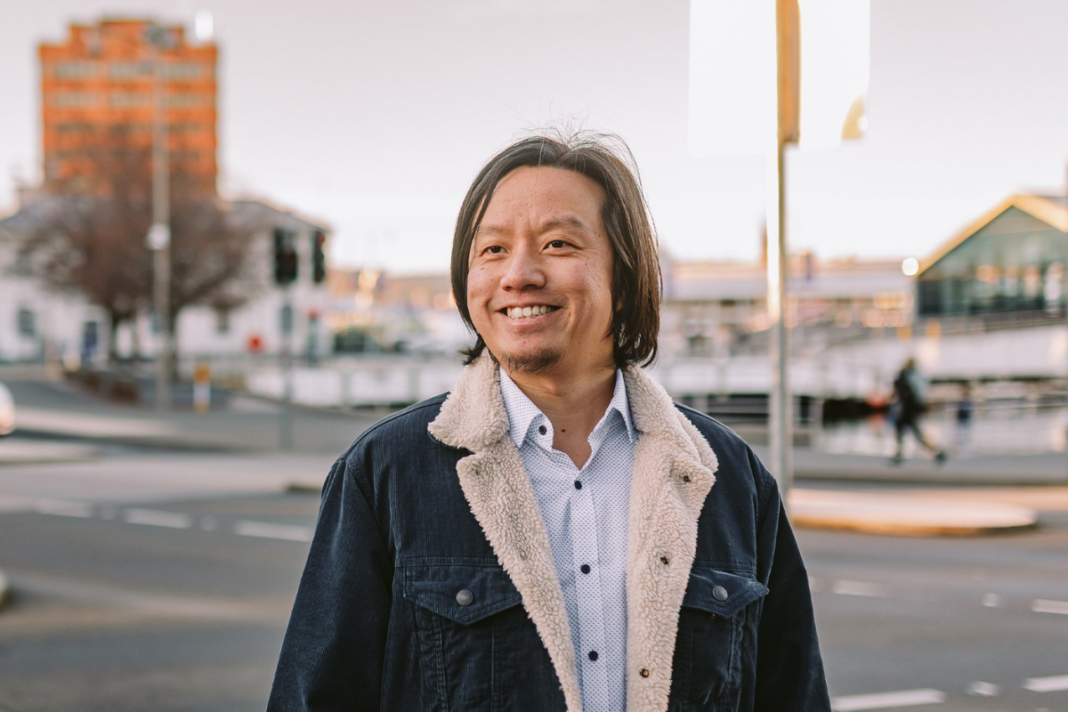 Danny standing in a street in Tasmania smiling
