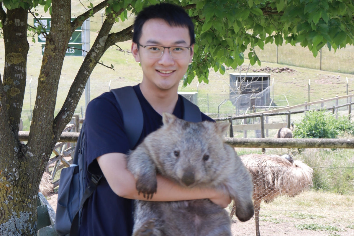 A photo of international student Jiaqing holding a wombat