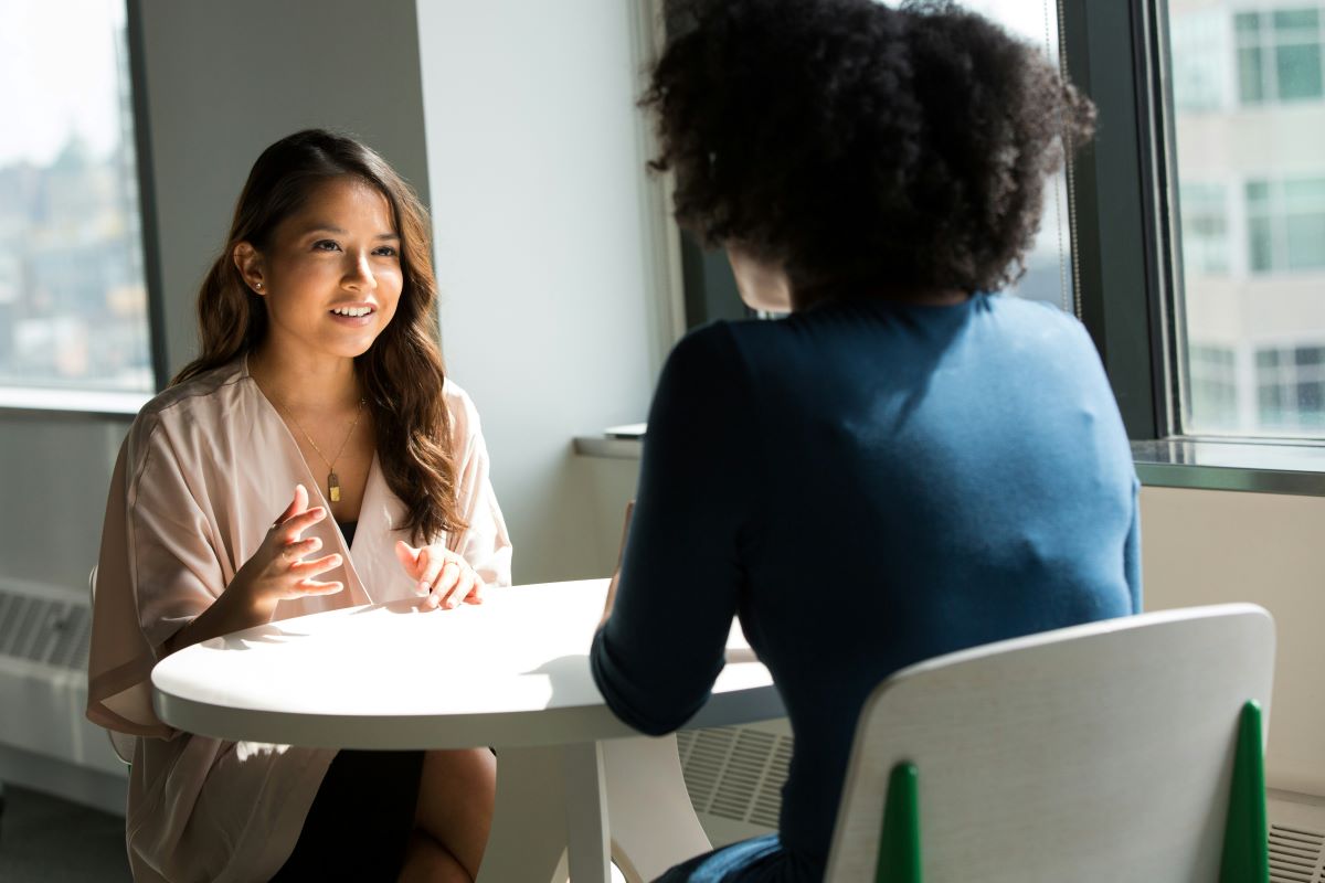 An international student sitting at a table in an interview