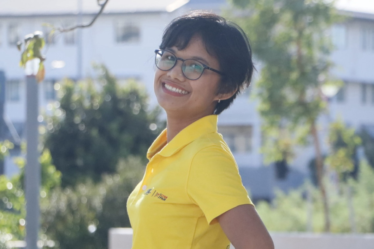 Mit outside her university campus smiling