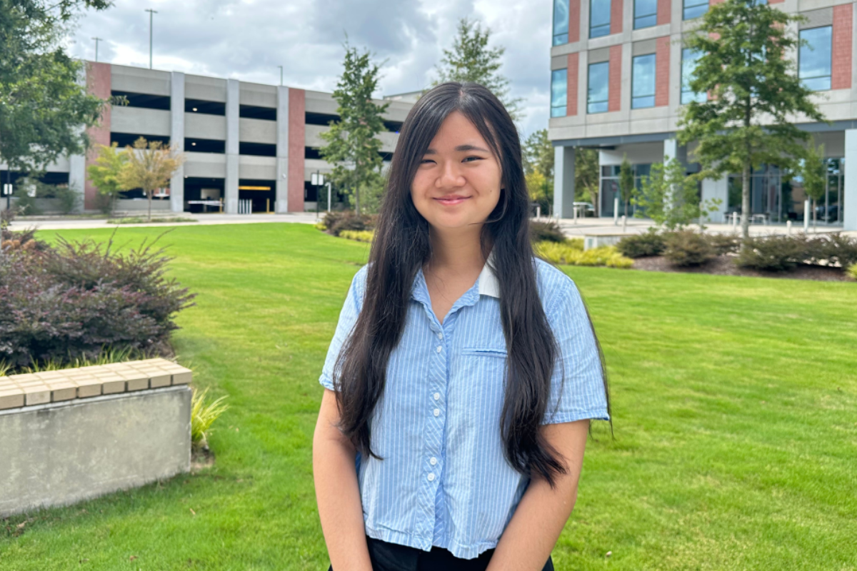 Yuka standing outside her campus smiling